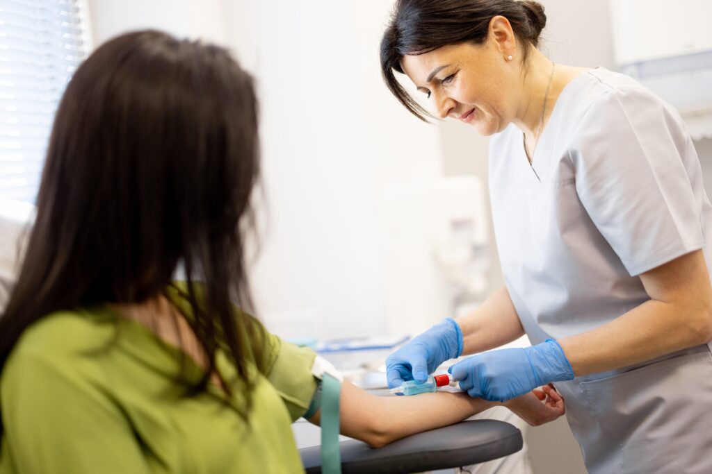 nurse taking patients blood test