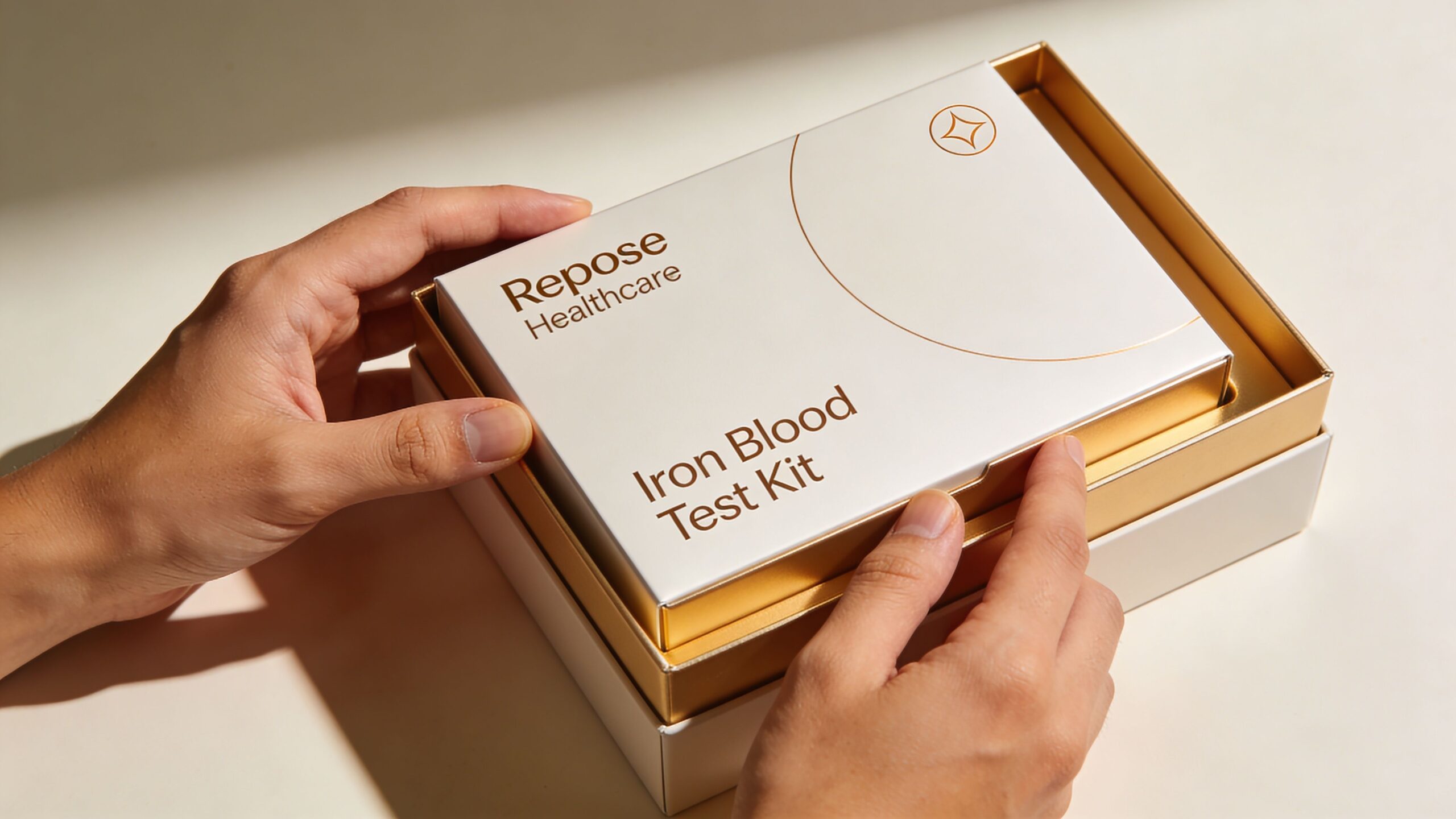 A person opening a premium white and gold box containing a Repose Healthcare iron blood test kit.